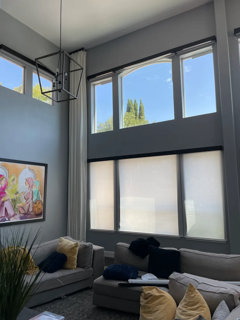 Roller shades and drapes in a living room